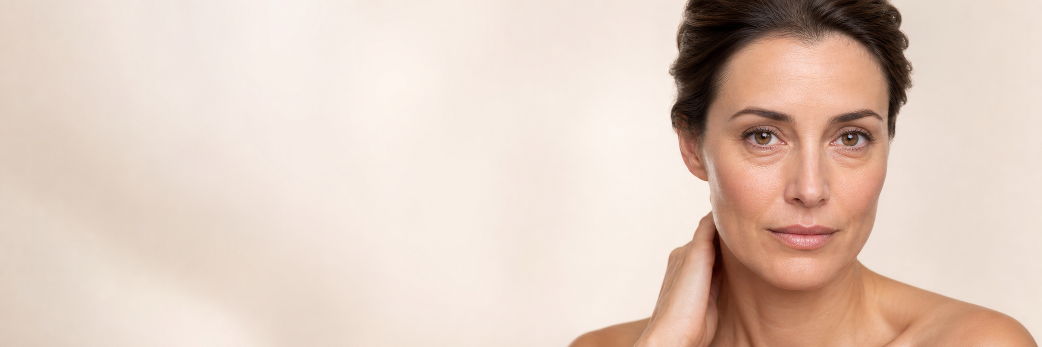 Woman with naturally visible under-eye puffiness in a light luxury beauty portrait